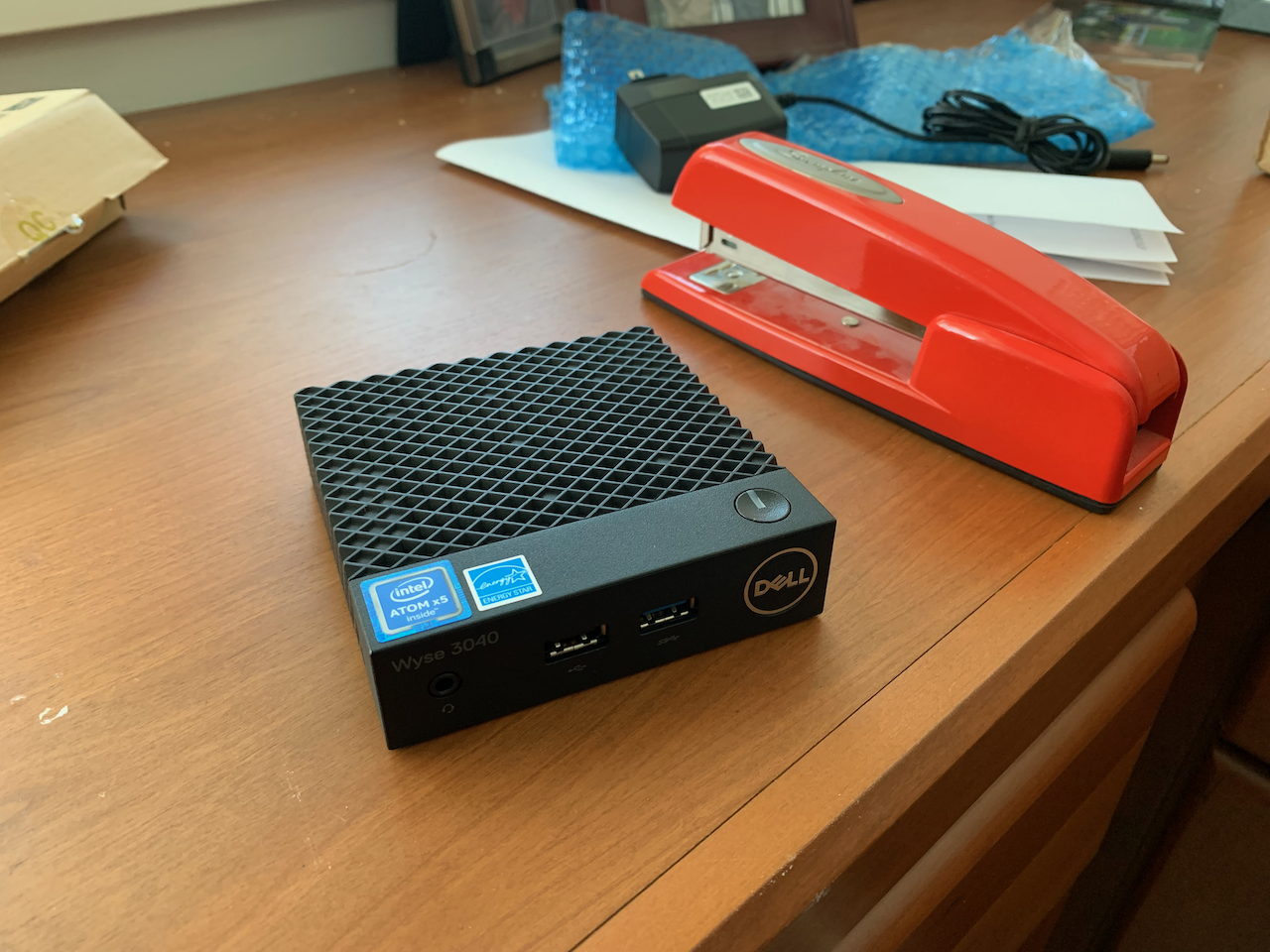 Dell Wyse 3040 thin client sitting on a desk with a red Swingline stapler for scale